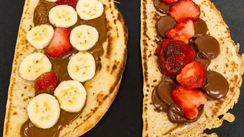 Crepes doces com banana, morango e chocolate preparados na hora